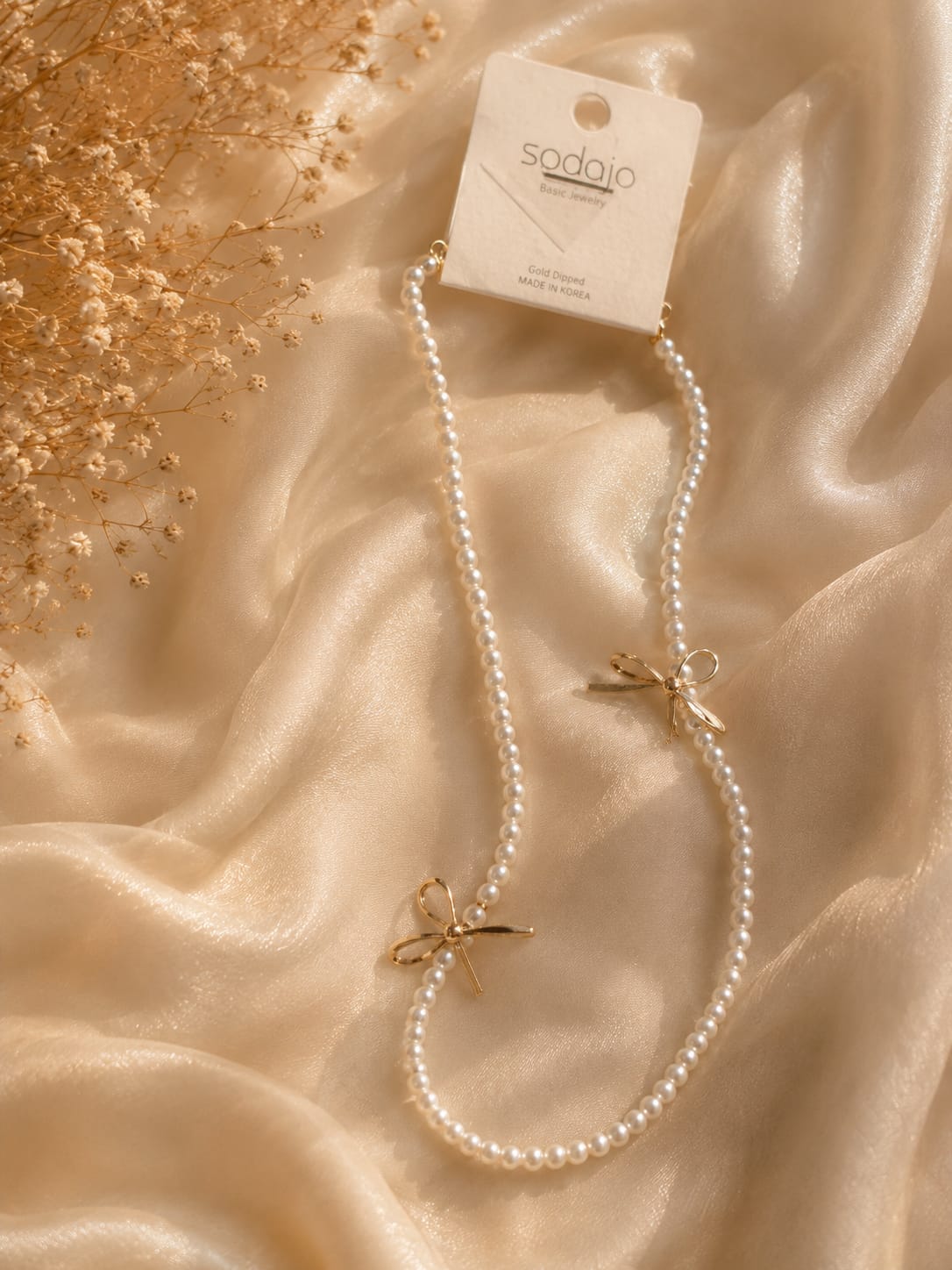 Sodajo collar aperlado con Moños dorados 93310N